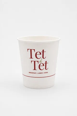 Custom branded paper cup with tea branding on white background