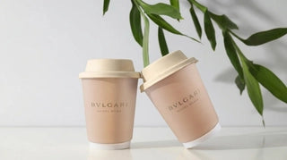 BVLGARI Hotel Roma branded paper cups with lids styled on a clean tabletop